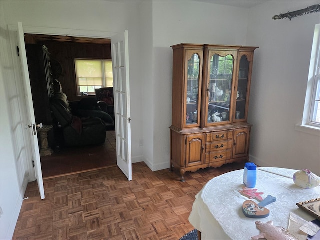 interior space with a healthy amount of sunlight and dark parquet flooring