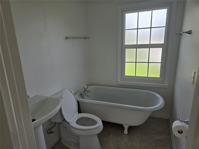 bathroom with toilet and a tub