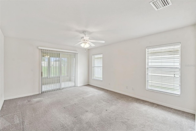 empty room with ceiling fan and light colored carpet