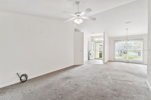 carpeted empty room with ceiling fan with notable chandelier, lofted ceiling, and a healthy amount of sunlight