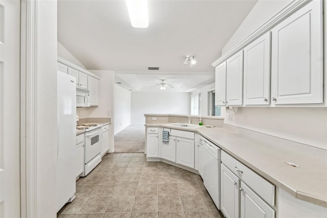 kitchen with white cabinets, kitchen peninsula, and white appliances