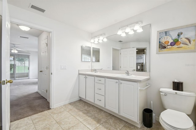 bathroom featuring ceiling fan, vanity, toilet, and tile patterned floors