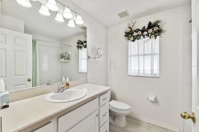 bathroom with tile patterned floors, curtained shower, vanity, and toilet