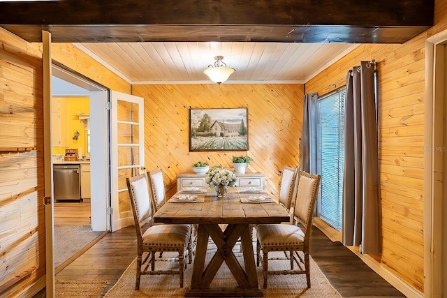 dining room featuring crown molding, hardwood / wood-style floors, and beamed ceiling