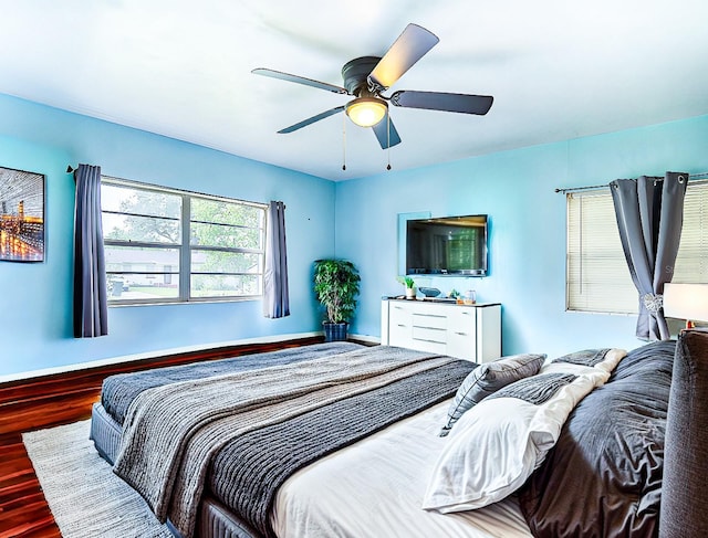 bedroom with wood-type flooring and ceiling fan