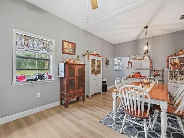 dining space with ceiling fan and light wood-type flooring