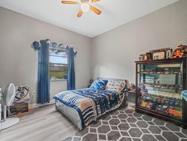 bedroom with ceiling fan and hardwood / wood-style flooring