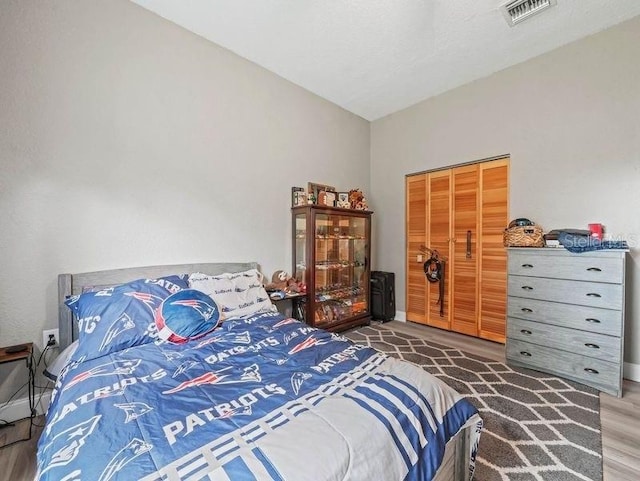 bedroom with a closet and dark wood-type flooring