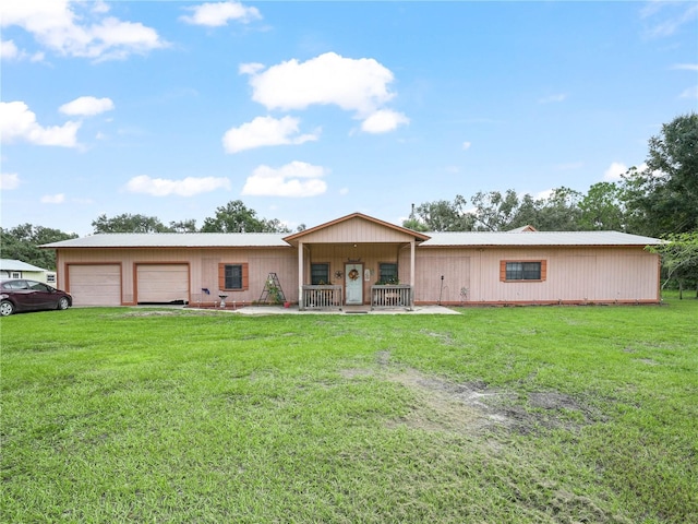 ranch-style home with a front yard, a garage, and a porch