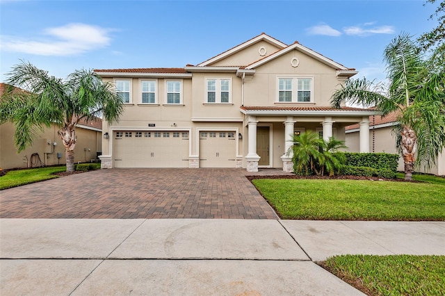 view of front of property with a garage and a front lawn