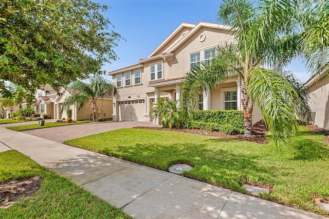 view of front of house featuring a garage and a front lawn