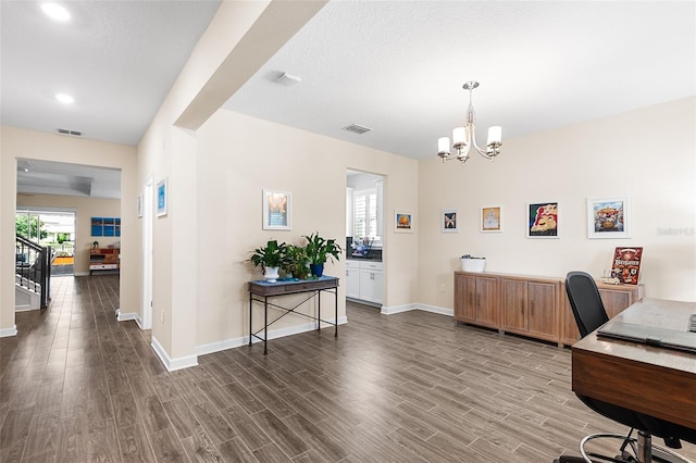 office area featuring a chandelier, dark hardwood / wood-style floors, and a textured ceiling