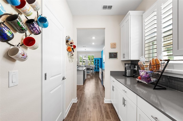 kitchen featuring white cabinetry and dark hardwood / wood-style flooring