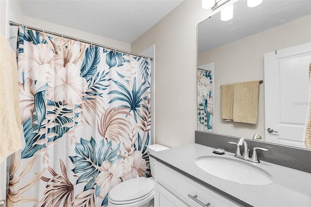 bathroom with a textured ceiling, a shower with curtain, vanity, and toilet