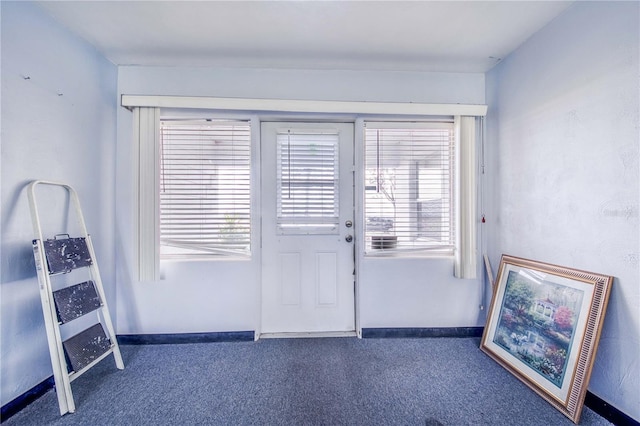 doorway to outside featuring dark colored carpet