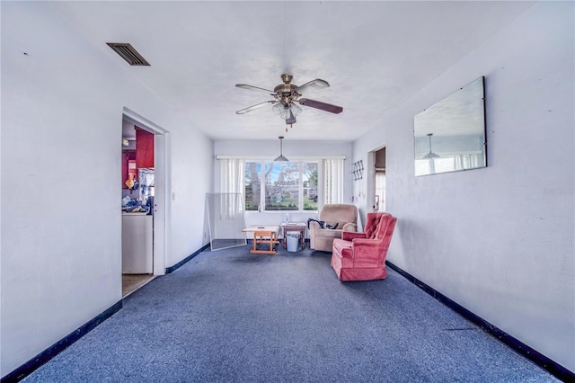 living area with dark colored carpet and ceiling fan