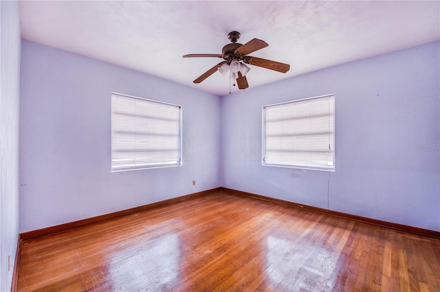 unfurnished room with ceiling fan and light wood-type flooring