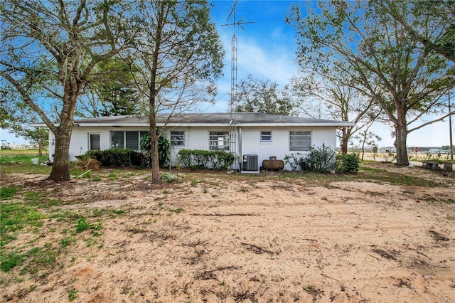 back of property featuring central AC unit