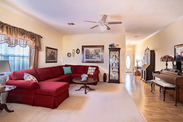 living room featuring ceiling fan with notable chandelier, light hardwood / wood-style floors, and crown molding