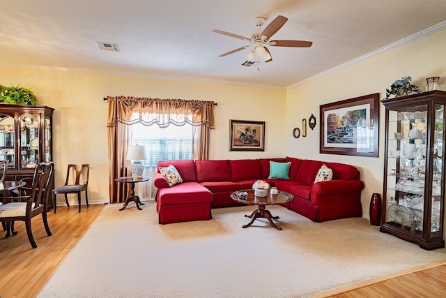 living room with ornamental molding, ceiling fan, and hardwood / wood-style flooring