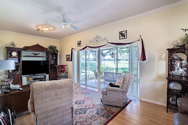 living room with ceiling fan, crown molding, and light hardwood / wood-style floors