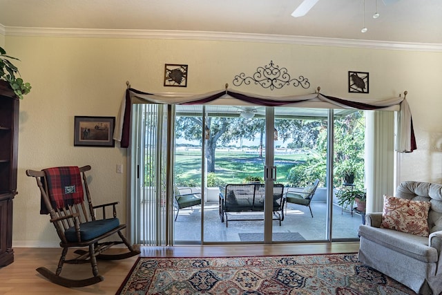 doorway to outside with wood-type flooring, crown molding, and ceiling fan