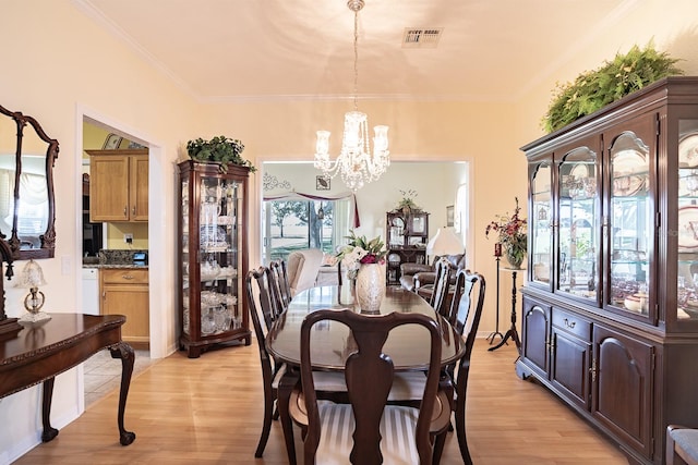 dining area featuring crown molding and light hardwood / wood-style floors