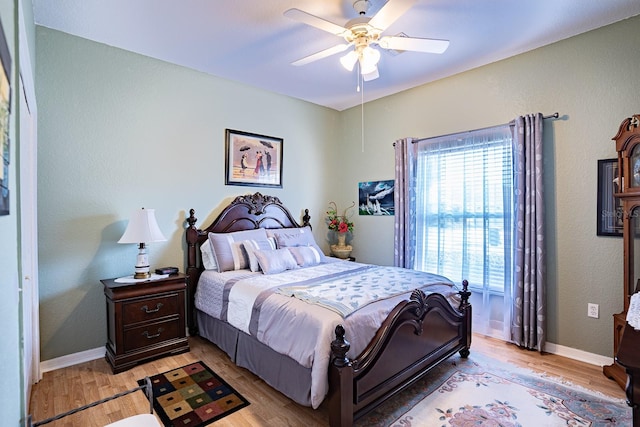 bedroom with ceiling fan and light hardwood / wood-style floors