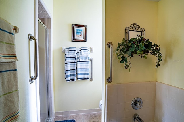 bathroom with tile patterned flooring, an enclosed shower, and toilet