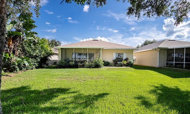 view of front facade featuring a sunroom and a front yard