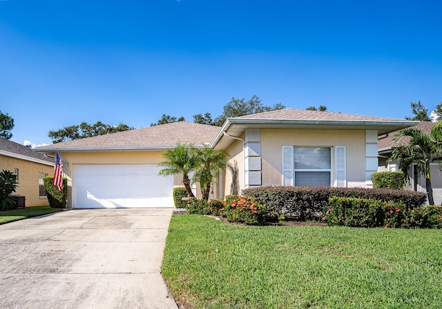 view of front of property with a garage and a front lawn