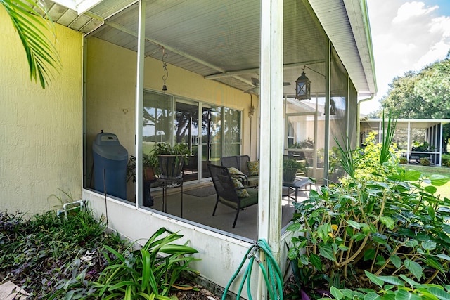 view of patio featuring a sunroom