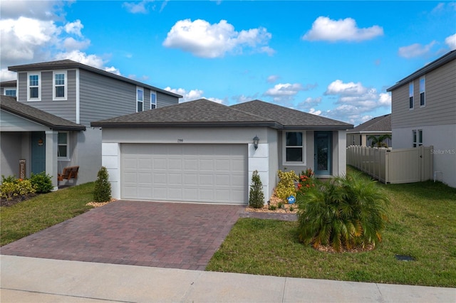 view of front facade featuring a garage and a front lawn