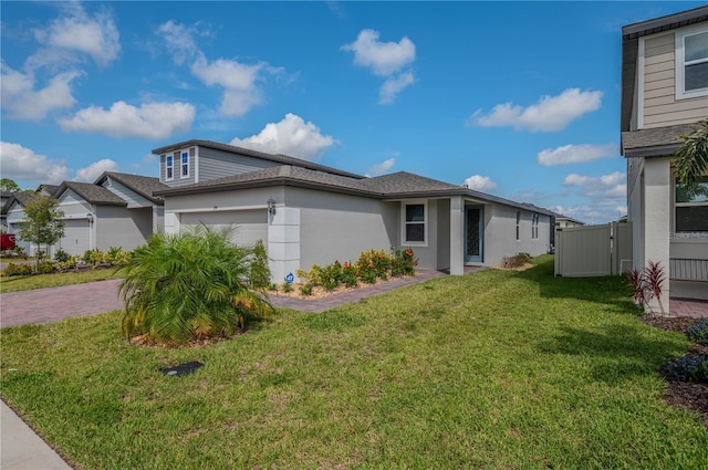 view of front facade with a garage and a front lawn