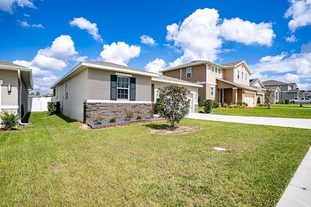 view of front of home featuring a garage and a front lawn