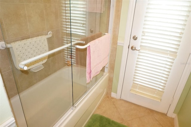 bathroom featuring shower / bath combination with glass door and tile patterned flooring