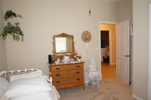 bedroom featuring light carpet