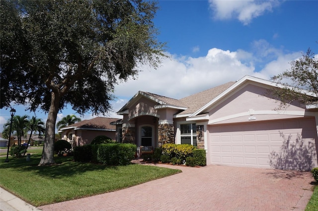 single story home featuring a garage and a front yard