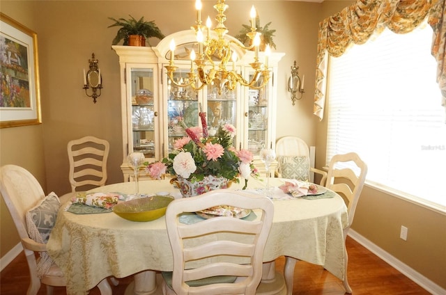 dining room with hardwood / wood-style flooring, a notable chandelier, and a wealth of natural light