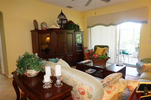 tiled living room featuring ceiling fan