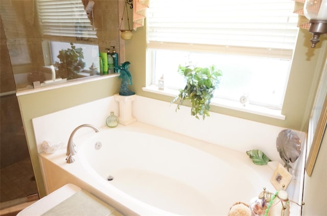 bathroom featuring shower with separate bathtub