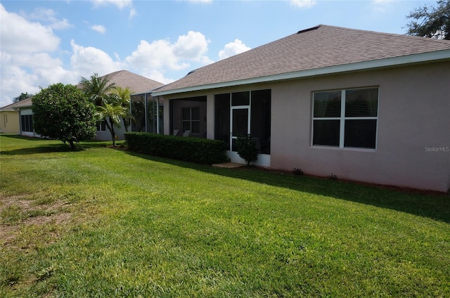 rear view of house with a lawn