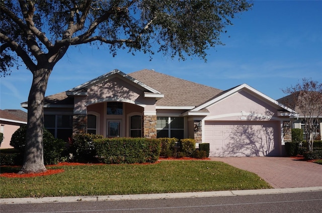 view of front of home with a garage and a front yard