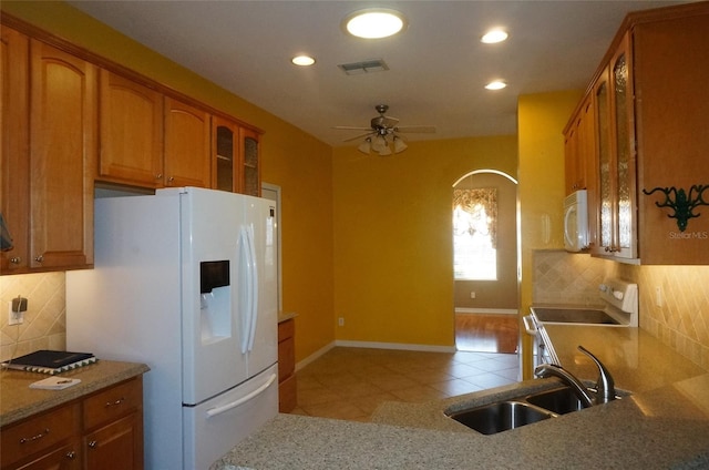 kitchen featuring sink, white appliances, decorative backsplash, and light tile patterned flooring