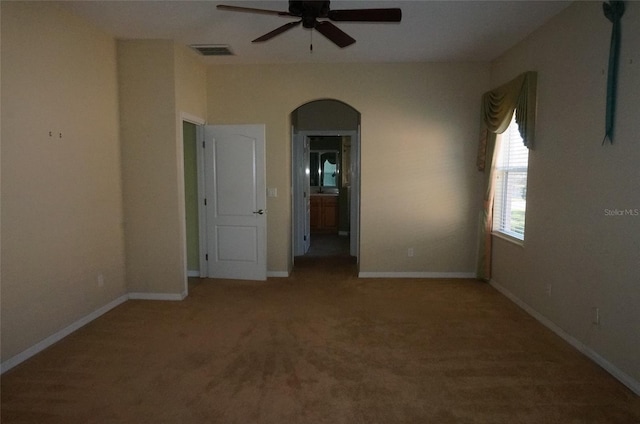 carpeted spare room with ceiling fan