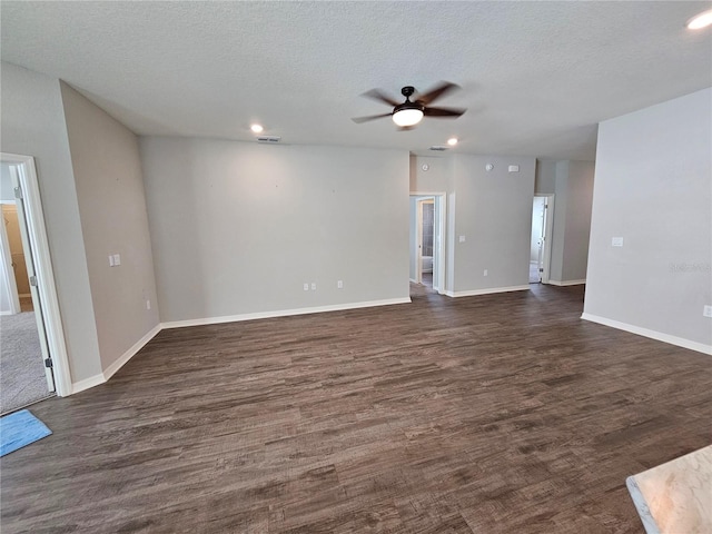 unfurnished living room with a textured ceiling, dark hardwood / wood-style floors, and ceiling fan