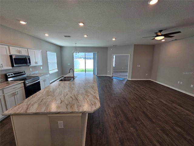 kitchen with an island with sink, white cabinets, appliances with stainless steel finishes, and sink