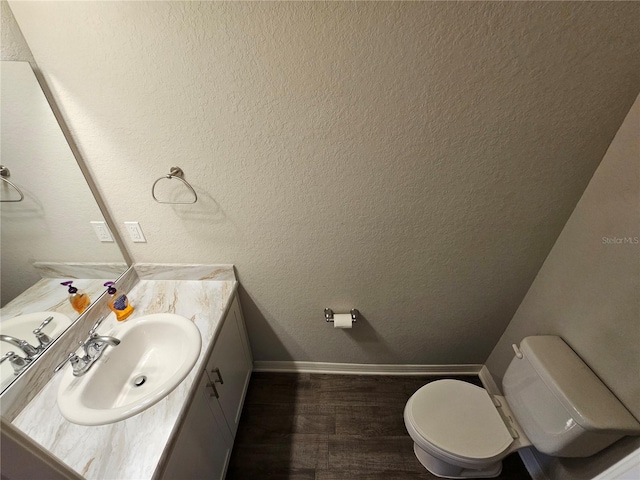 bathroom featuring vanity, toilet, and hardwood / wood-style flooring