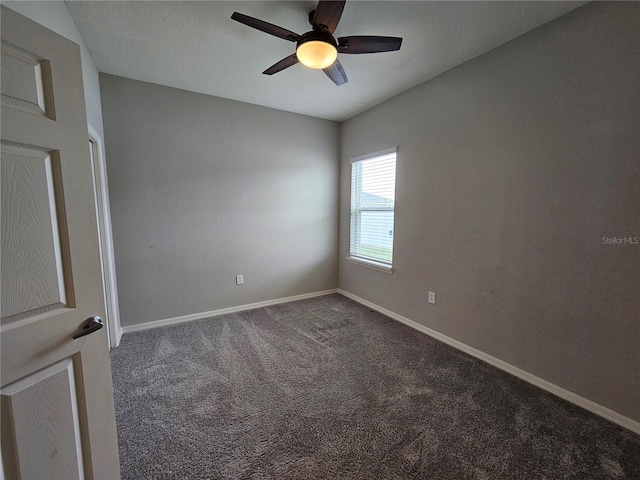 carpeted spare room featuring ceiling fan