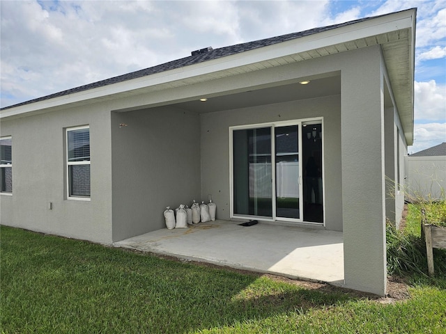 back of house featuring a yard and a patio